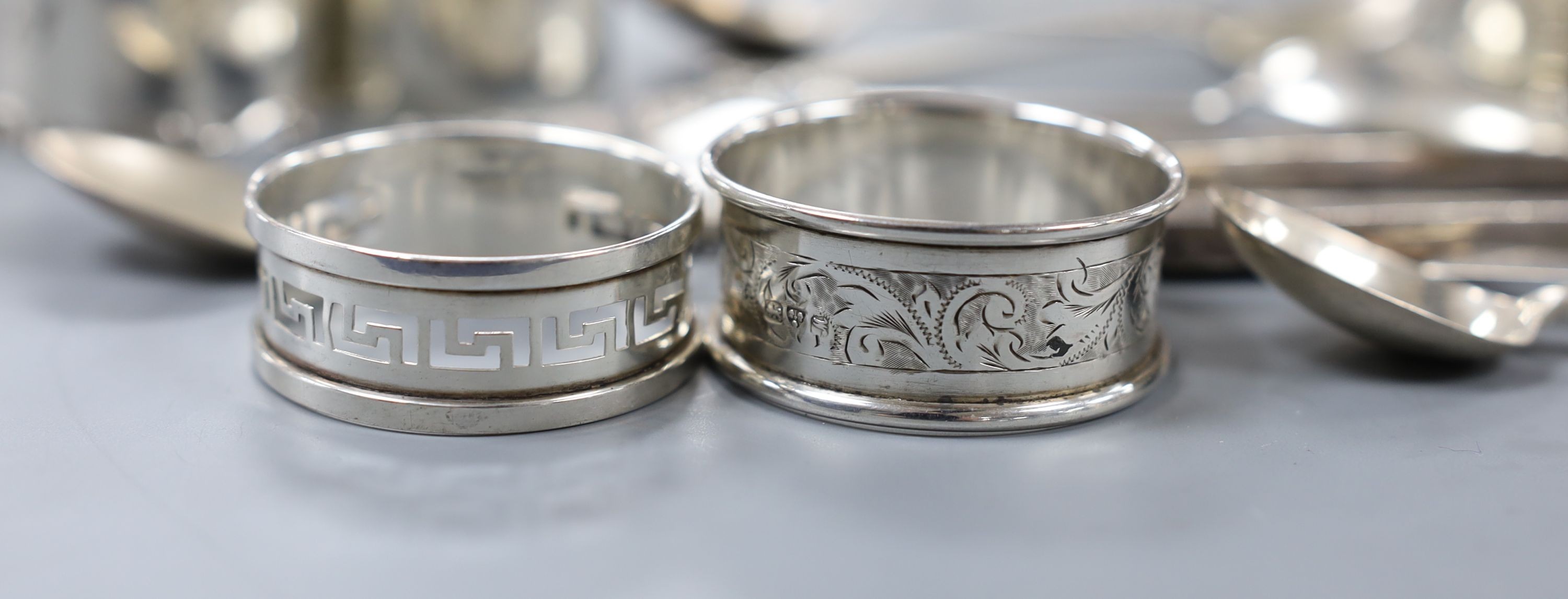 A quantity of small silver cutlery, a pair of silver decanter labels, Sherry and Whisky and eight various silver serviette rings.